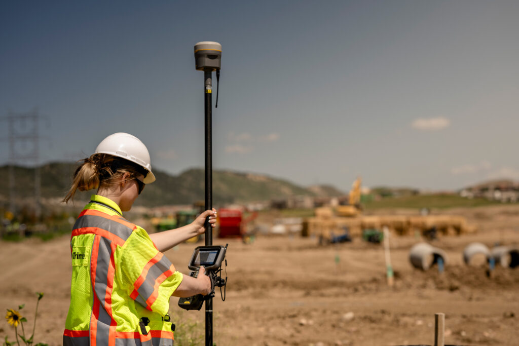 Trimble TSC510 controller in use on construction site for precise data collection and stakeout.
